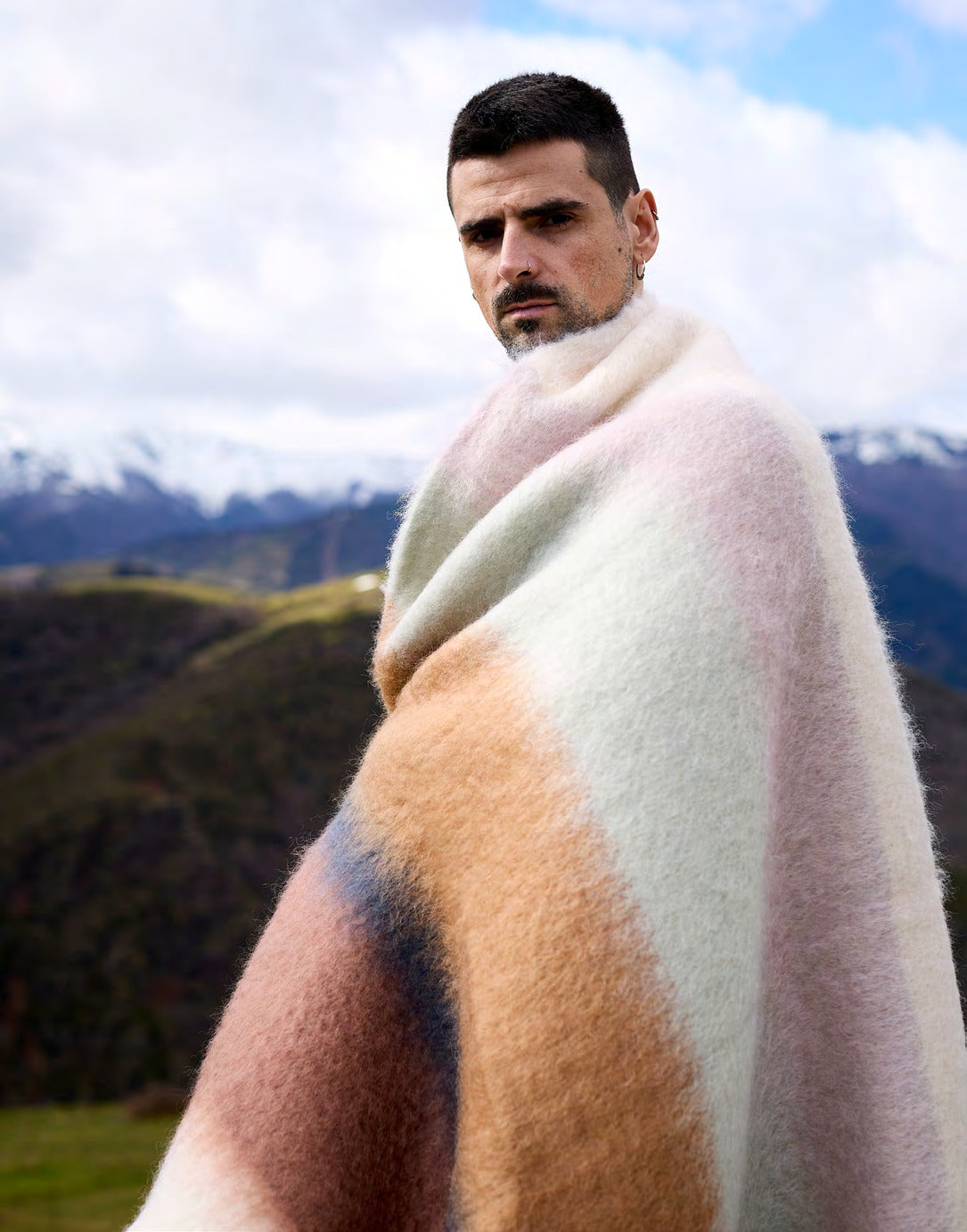 Man gehuld in een Mantas Ezcaray Serenity mohairplaid in de bergen van La Rioja, Spanje